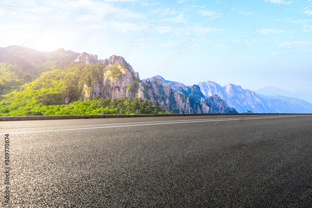 Asphalt highway and mountain with beautiful clouds landscape.