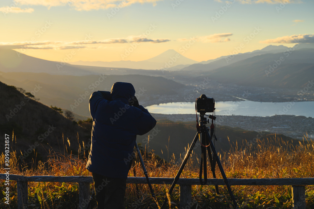 Outdoors photographer photographs Mt.Fuji in morning