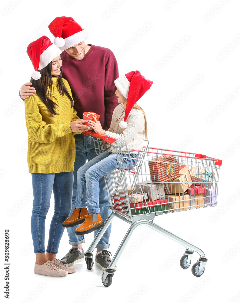 Family with shopping cart full of Christmas gifts on white background