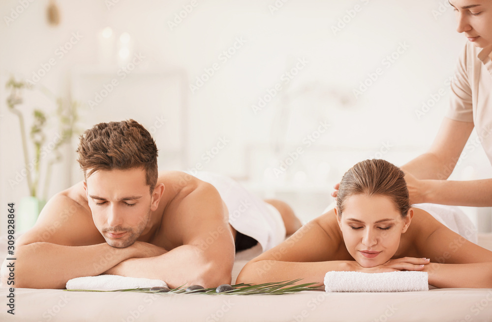 Young couple having massage in spa salon