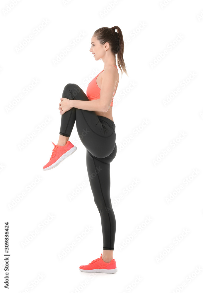 Sporty young woman training against white background