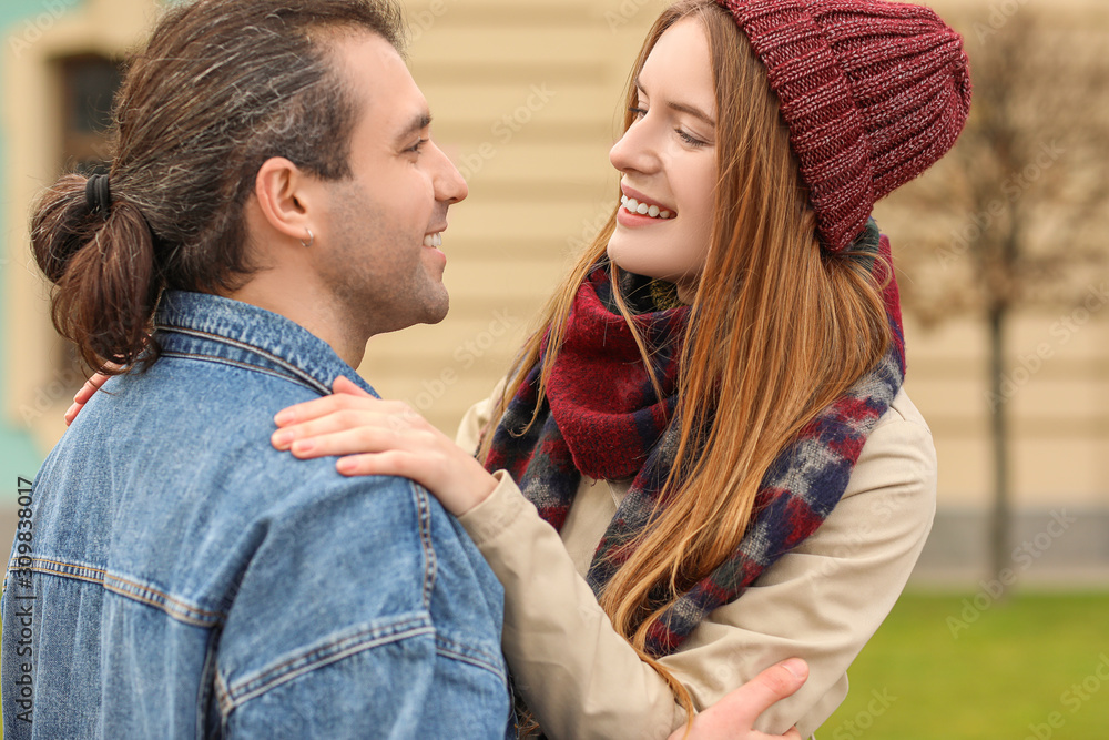 Happy couple walking in autumn city