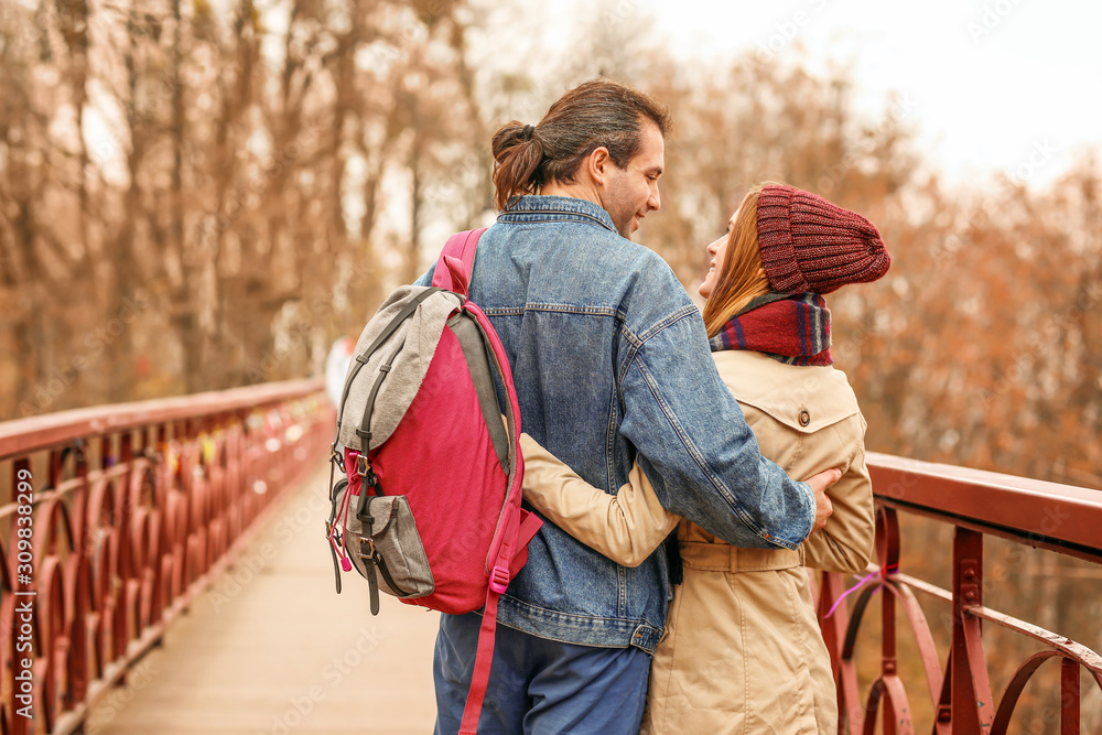 Happy couple on bridge in autumn city