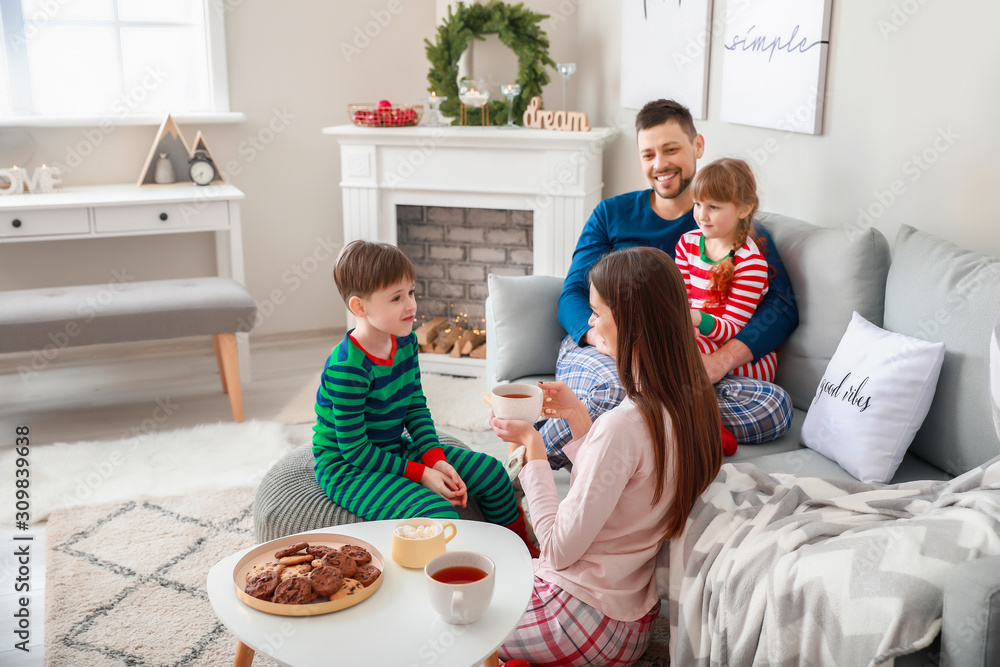 Happy family drinking hot tea at home