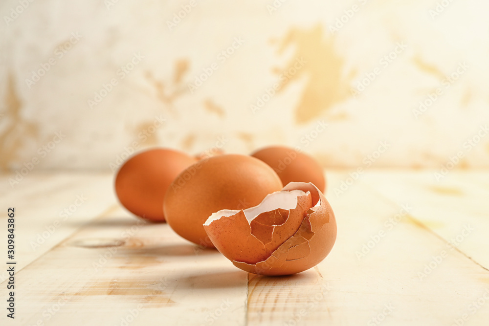 Fresh eggs on white wooden background