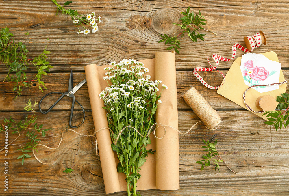 Workplace of professional florist on wooden background