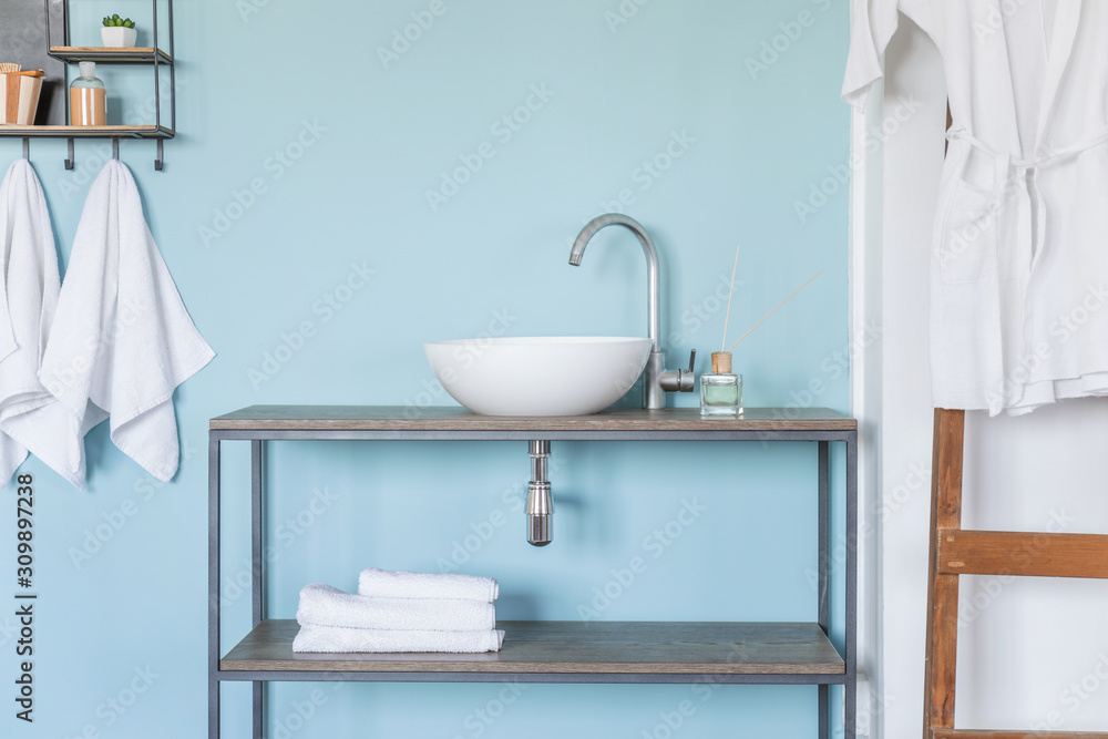 Interior of clean bathroom with sink near color wall