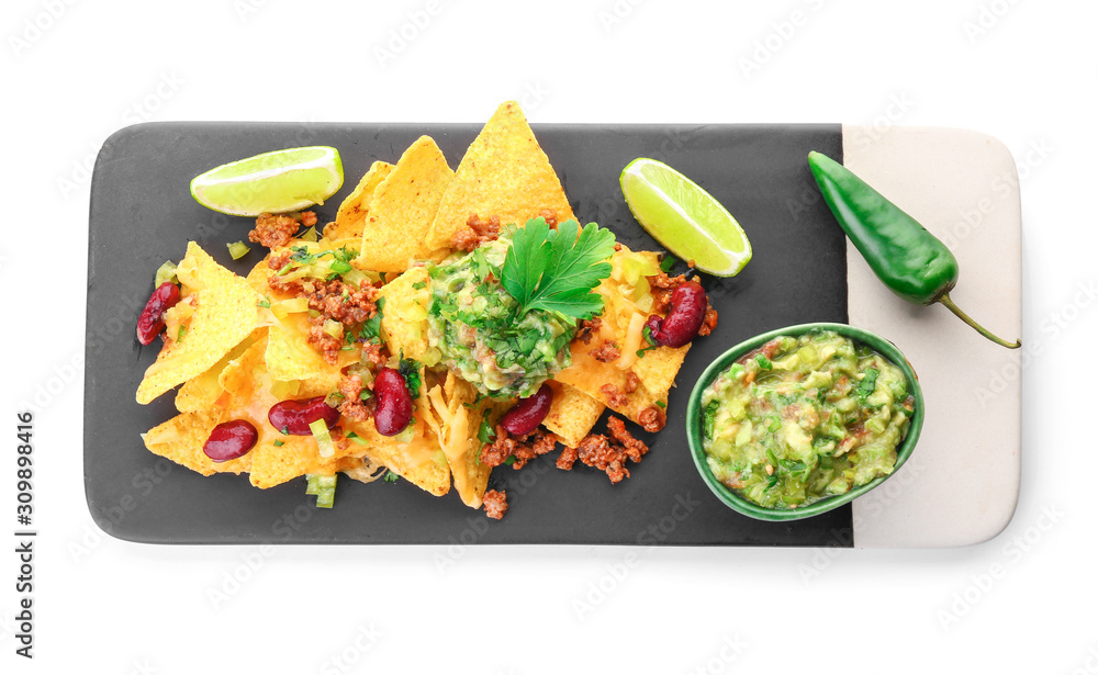 Board with tasty nachos and guacamole on white background