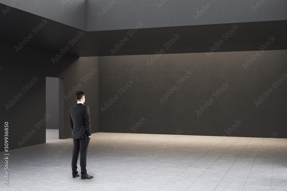 Businessman in modern gallery interior