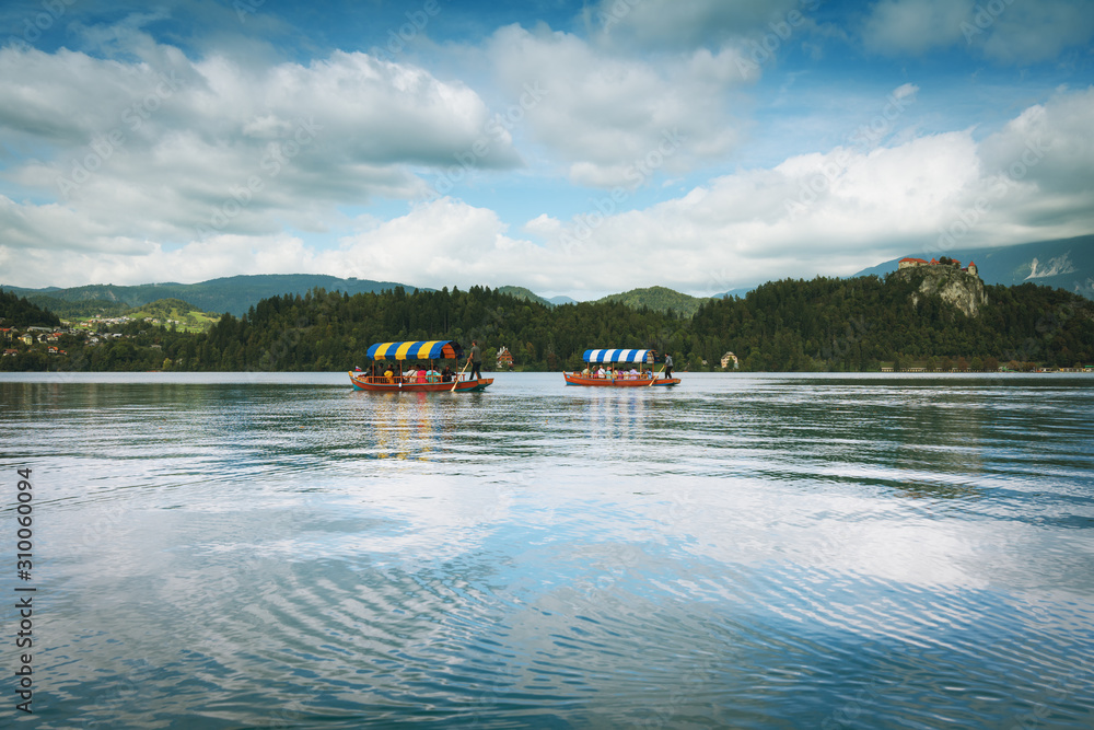 Beautiful landscape of lake Bled (Blejsko jezero) in Slovenia with distant view of tourists taking a