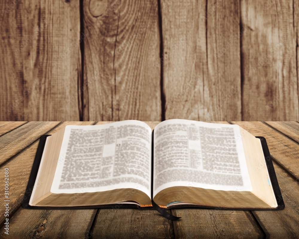 Open vintage Christian bible on desk