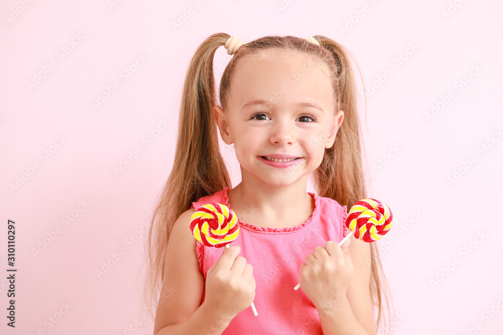 Cute little girl with sweet lollipops on color background