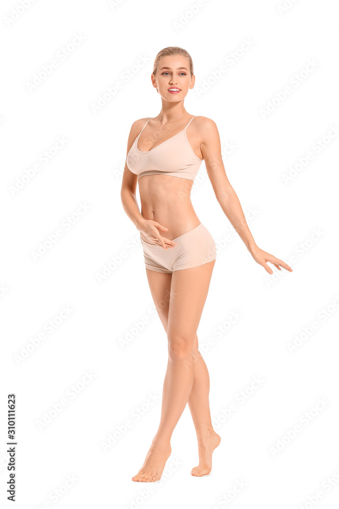 Beautiful young woman in underwear on white background