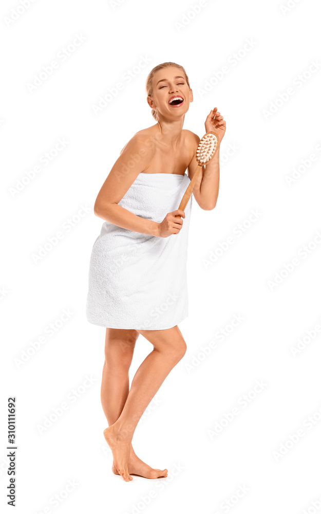 Beautiful young woman with brush for bath on white background