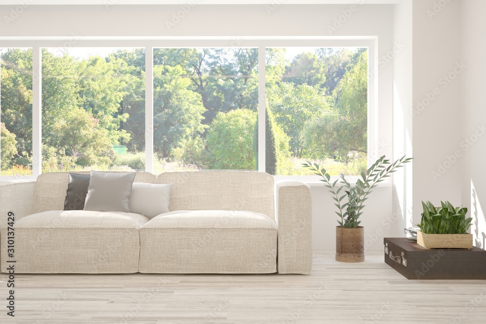 Stylish room in white color with sofa and summer landscape in window. Scandinavian interior design. 