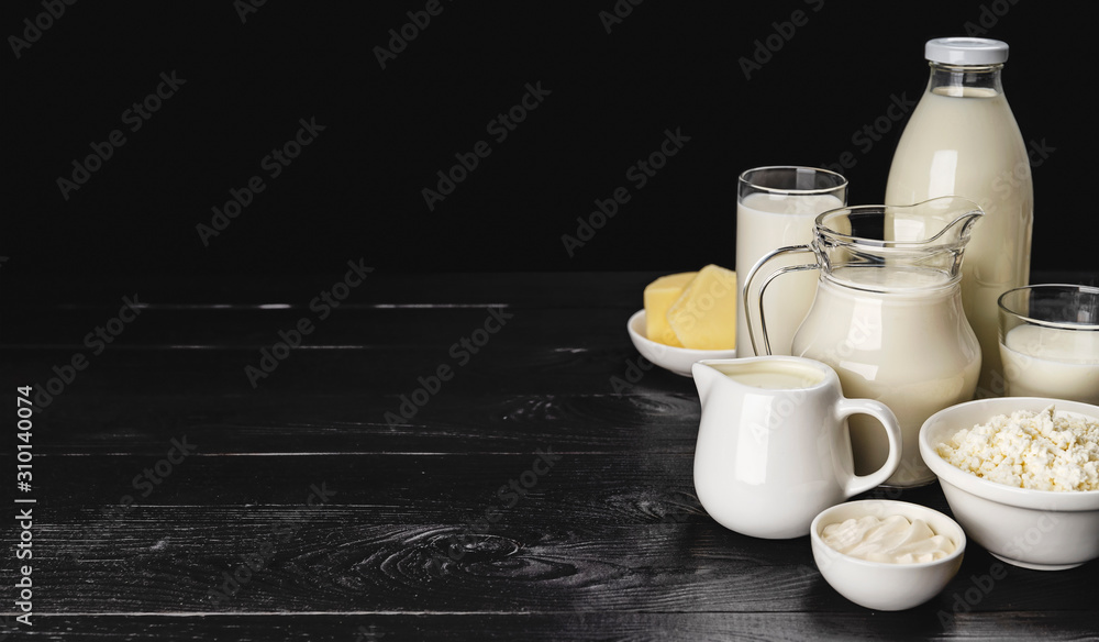 Dairy products on black wooden background