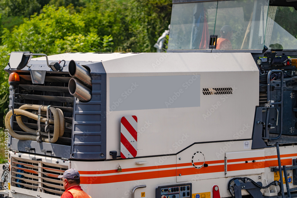 Asphalt skating rink. Road equipment for asphalt work. Pavement repair work. Cropped photo, closeup