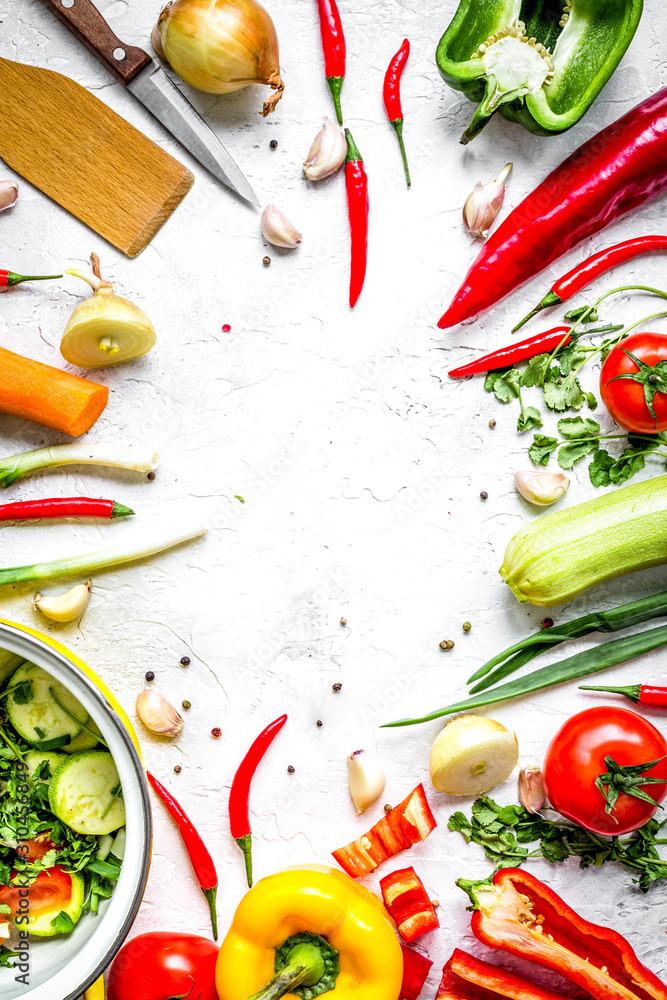 cooking vegetables on the stone background top view