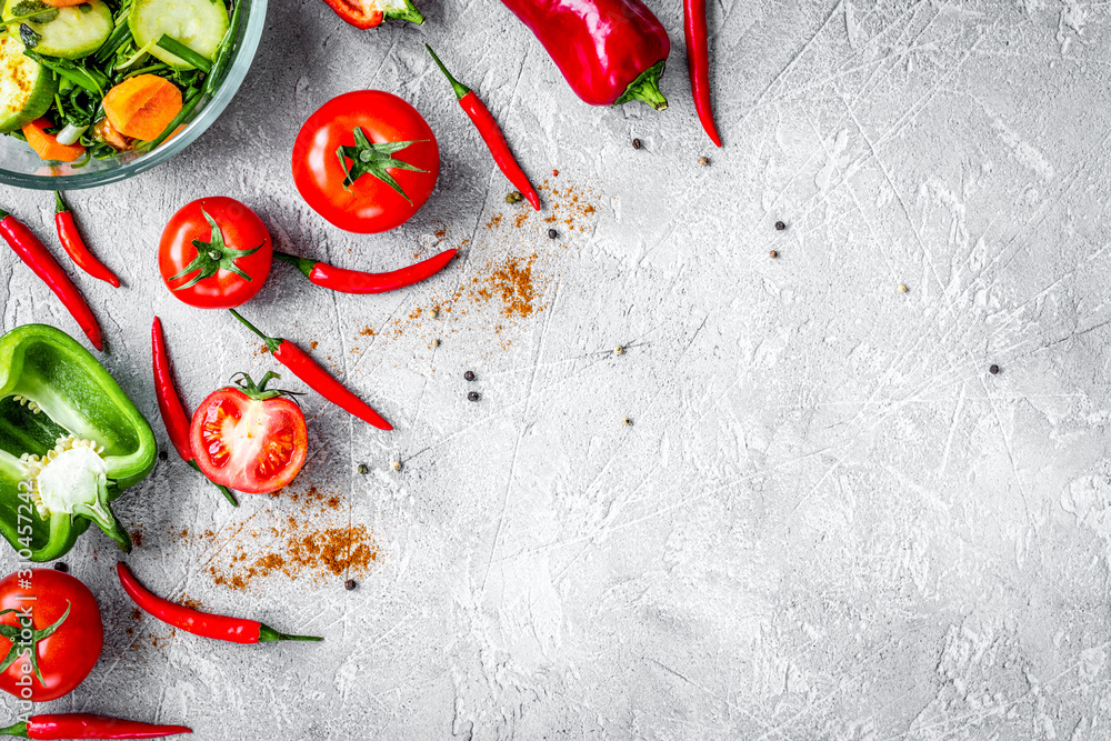 cooking vegetables on the stone background top view