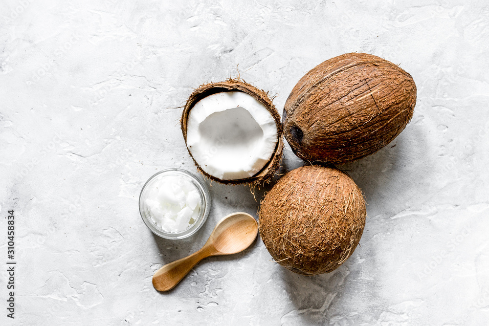 organic cosmetics concept with coconut on table background top view