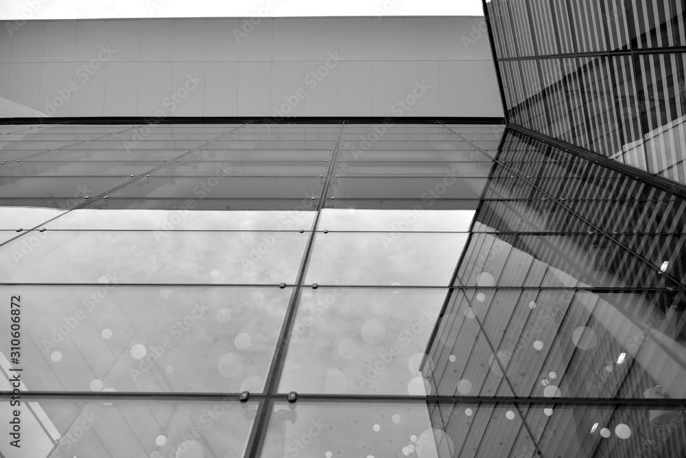 Sun rays light effects on urban buildings in sunset. Modern office building detail, glass surface wi