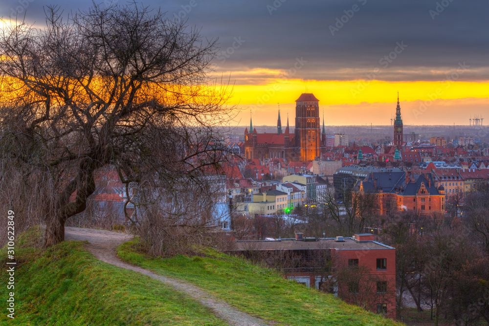 Beautiful cityscape of Gdansk with St. Mary Basilica and City Hall at sunrise, Poland.