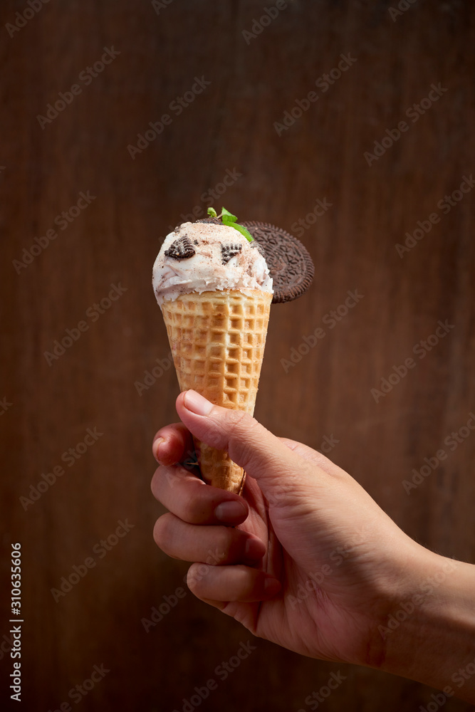 Sweet homemade ice cream with cookies in cone, selective focus