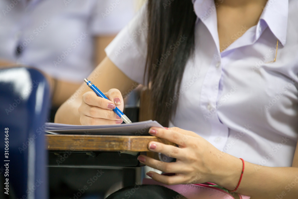 high school,university student study.hands holding pencil writing paper answer sheet.sitting lecture