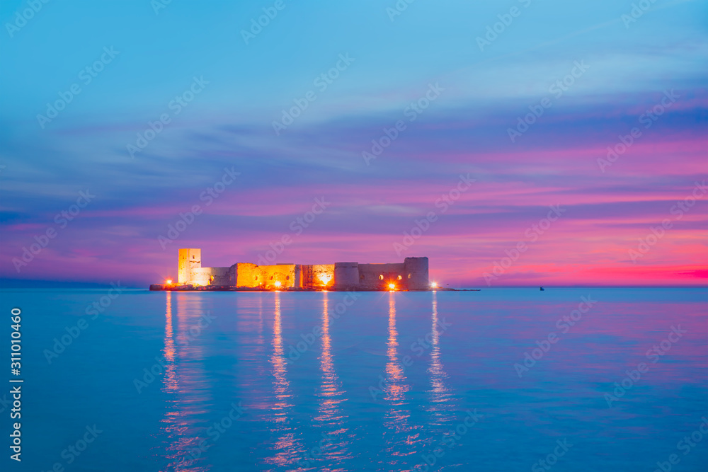 The maidens castle at twilight blue hour (Kiz Kalesi) with full moon - Mersin Turkey