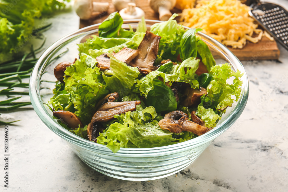 Bowl with tasty mushroom salad on white background