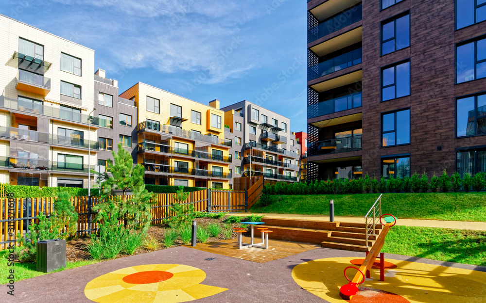 Children playground at Modern architectural complex of residential buildings reflex