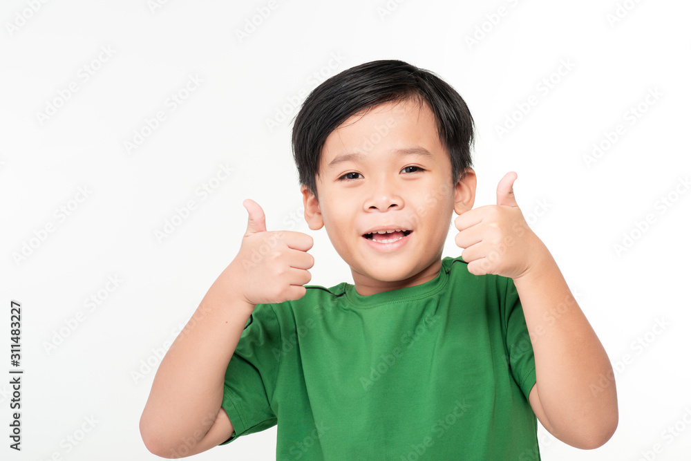 Very happy Asian boy making thumbs up sign with hands laughing happily (Asian ethnicity boy isolated