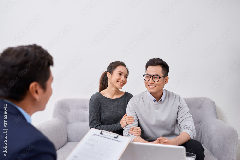 Happy young couple hold each otherâ??s hands listening to female agent, planning wedding, consulting