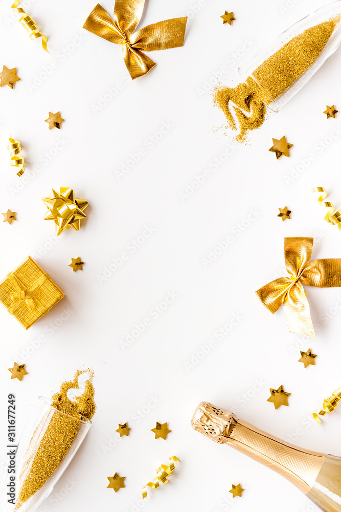 New Year mockup in gold color. Champagne bottle, present box, decoration on white background top-dow