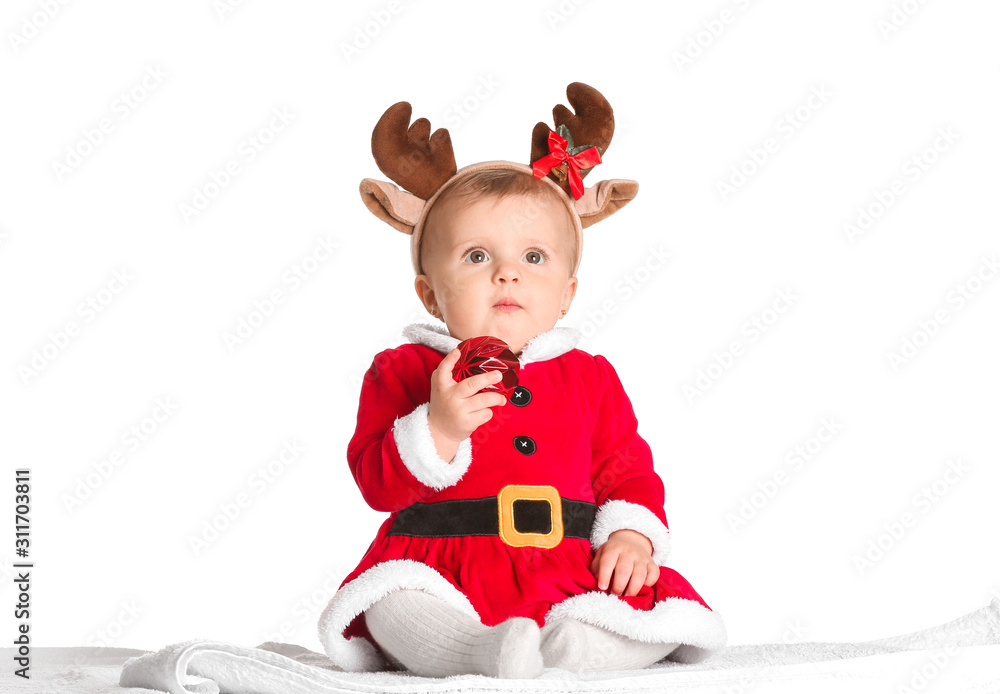 Cute little baby in Santa Claus costume and with Christmas ball on white background