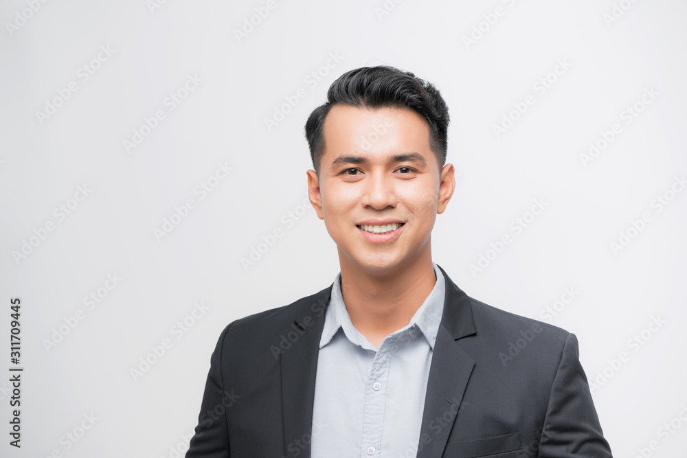 Confident Asian businessman smiling and looking at the camera