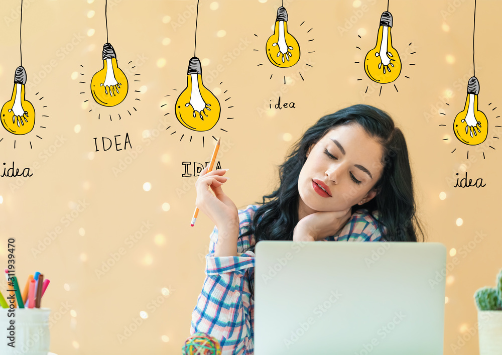 Idea light bulbs with young woman holding a pencil