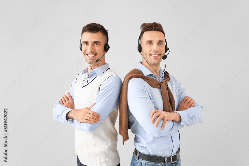 Team of technical support agents on light background