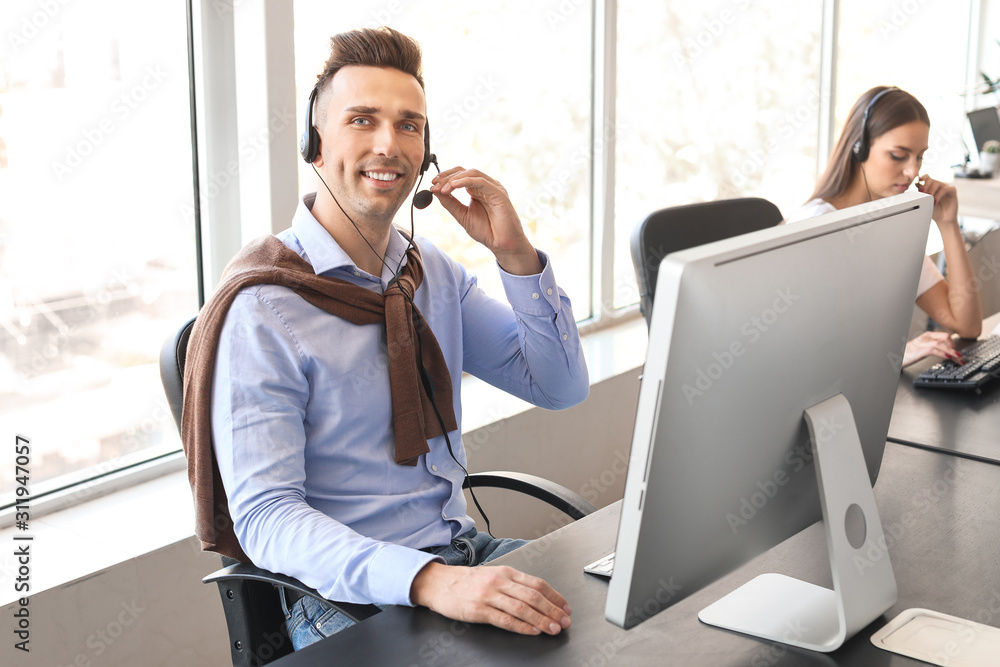 Male technical support agent working in office