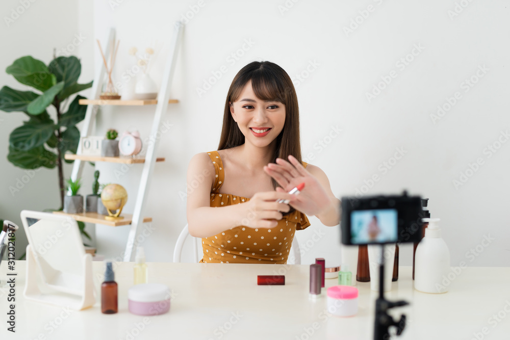 What is this. Pretty young woman sitting in front of the camera while testing cosmetics