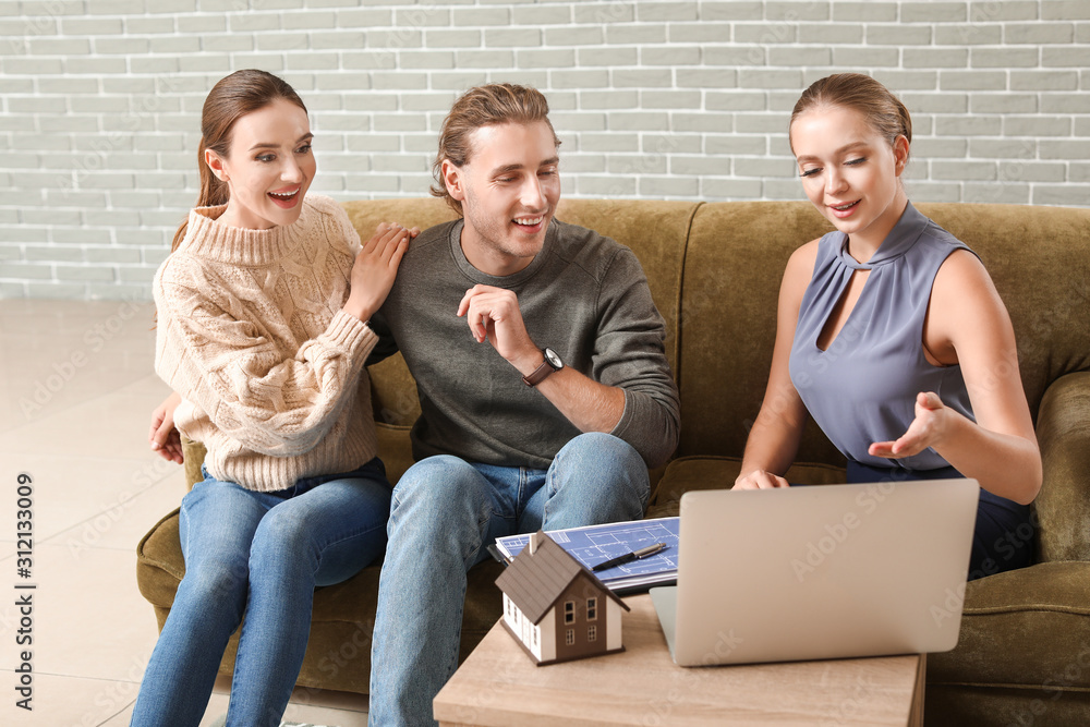 Young couple in office of real estate agent