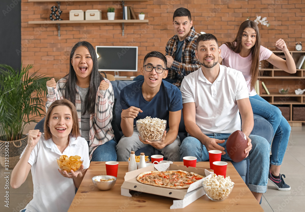 Group of fans watching rugby on TV