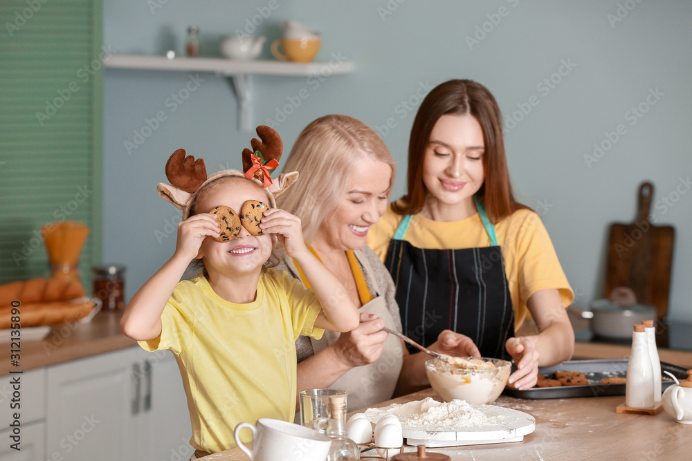 年轻女子带着她的小女儿和母亲在家做圣诞饼干