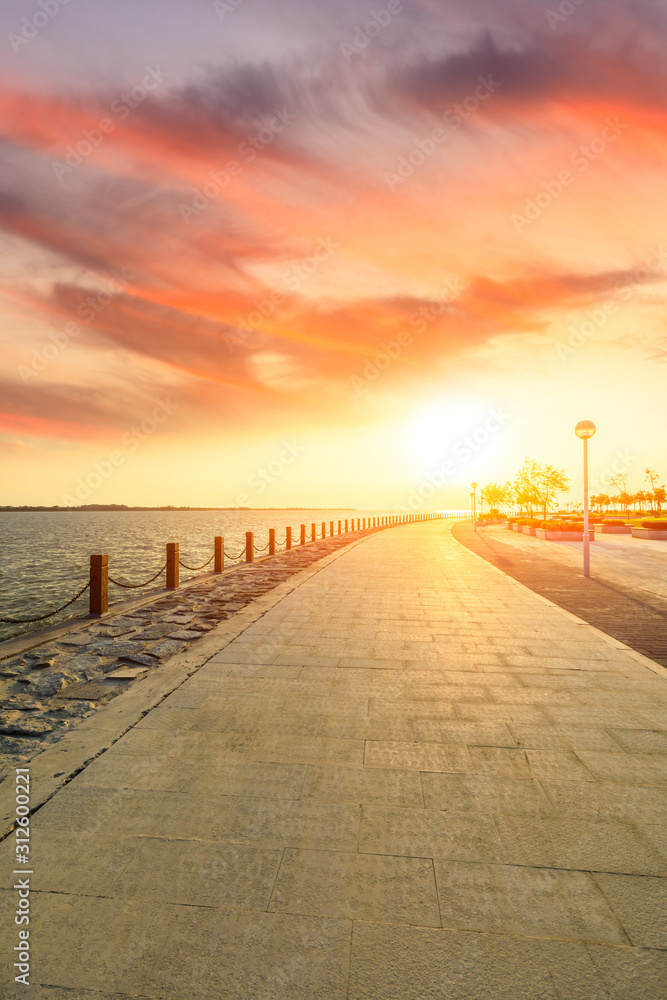 Lakeside road and beautiful sunset sky in the park.