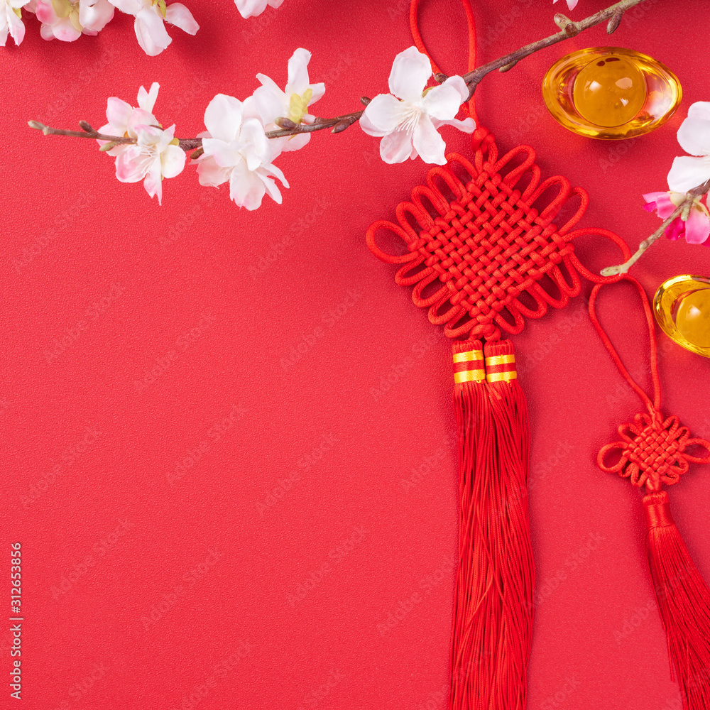 Design concept of Chinese lunar new year - Beautiful Chinese knot with plum blossom isolated on red 