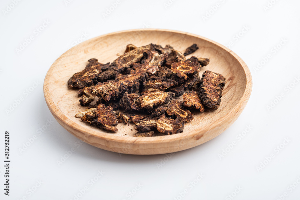 A plate of Chinese medicinal herbs tincture live on white background