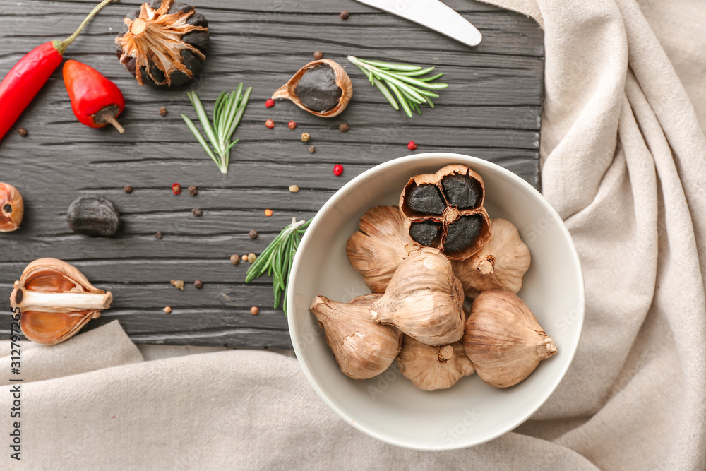 Composition with black garlic on table