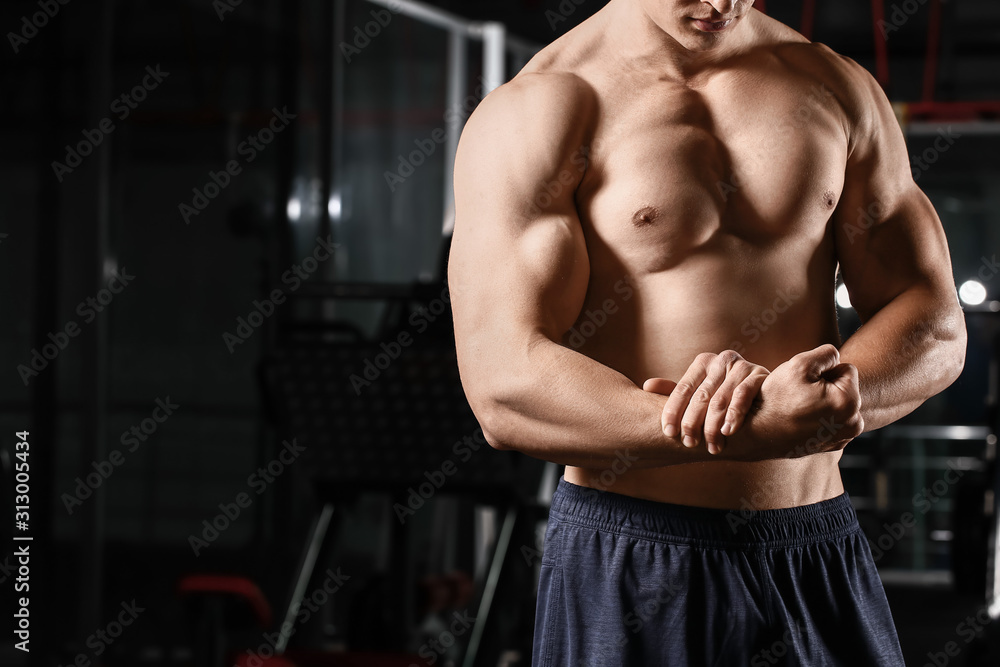 Sporty muscular man in gym