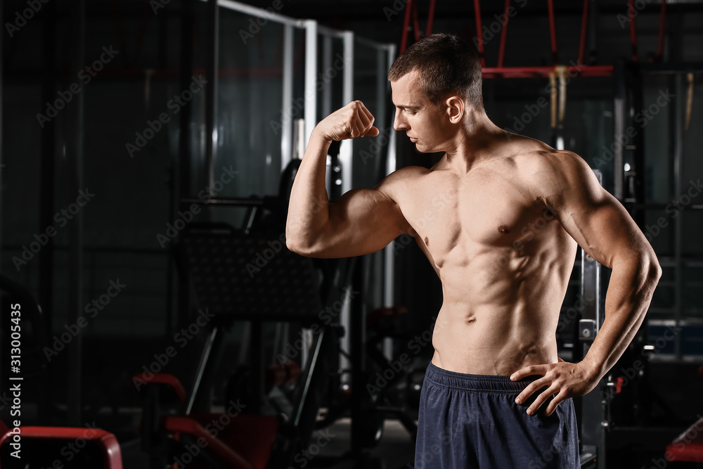 Sporty muscular man in gym