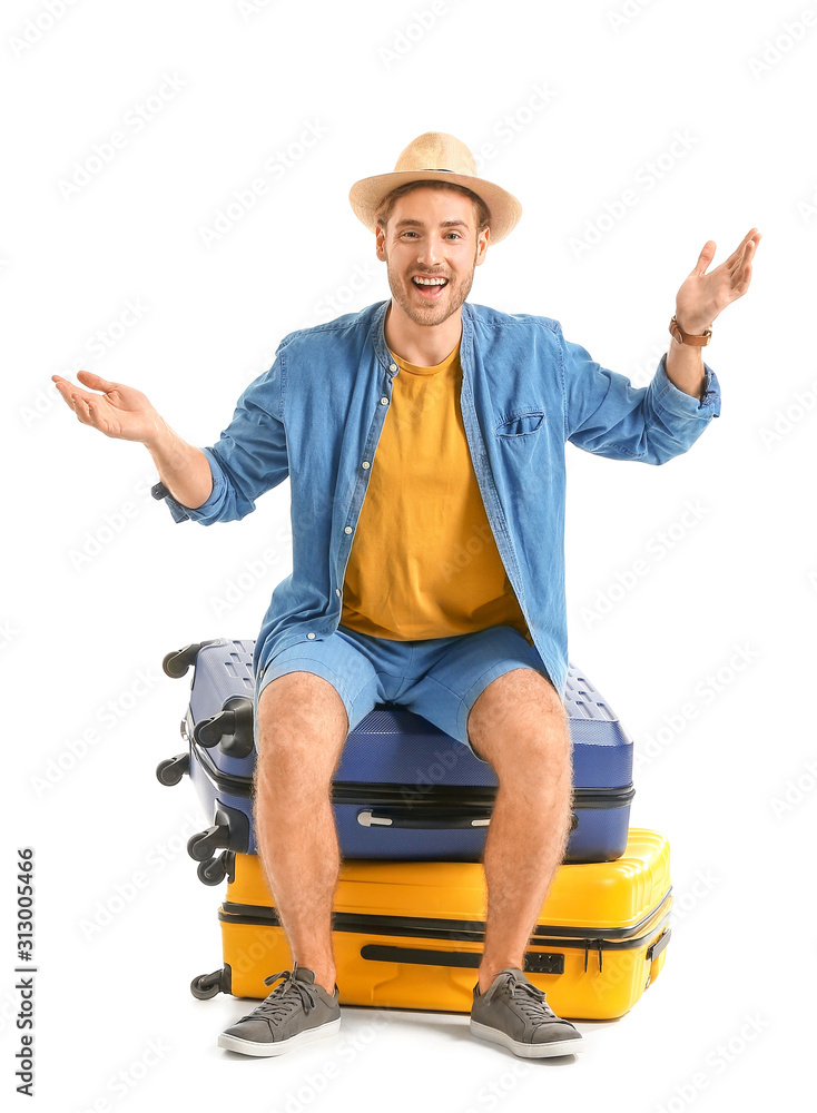 Young tourist with luggage isolated on white